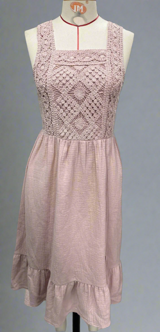 Close-up of intricate crochet detailing on the bodice and soft fabric of the maxi-length skirt.