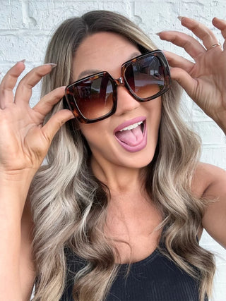 Model wearing Bora Bora Babe Sunglasses with beachy waves and a carefree summer vibe in tortoise.
