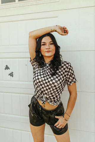 Trendy mesh short-sleeve top with hidden western text and black-and-white checks.