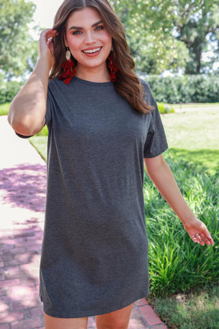 Woman wearing the Bailey Basic T-Shirt Dress, styled casually for a relaxed yet chic look.