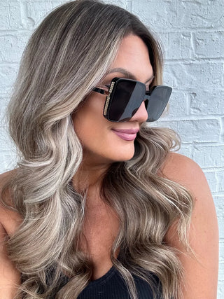 Close-up of Antigua Sunglasses showing gold frames and lightly tinted lenses.