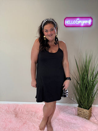 Woman wearing the Backless and Breezy Dress, styled casually for a chic, free-spirited look