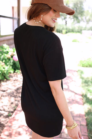 Woman wearing the Bailey Basic T-Shirt Dress, styled casually for a relaxed yet chic look.