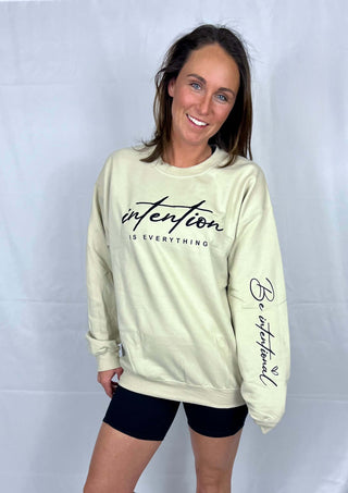 Woman wearing the Be Intentional Sweatshirt, styled casually for a comfortable, uplifting look.