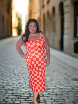Woman wearing the Bishop Checkered Bodycon Dress, styled for a chic, bold look perfect for a night out or event.
