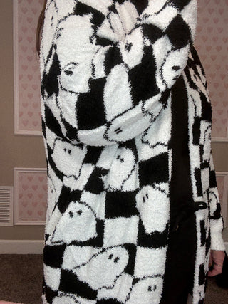 Black and white checkered cardigan with ghost pattern.