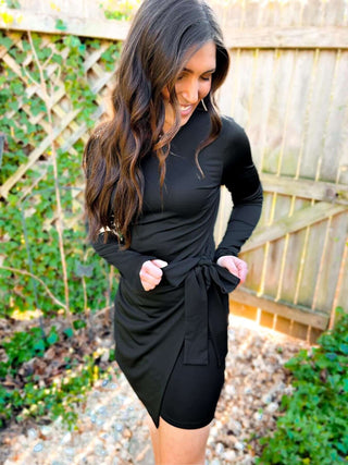 Woman wearing the Carrie Crossover Waist Faux Wrap Dress, styled for a chic and elegant look perfect for any occasion.