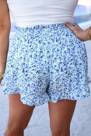 Back view of shorts highlighting smocked stretch fit and soft floral pattern.