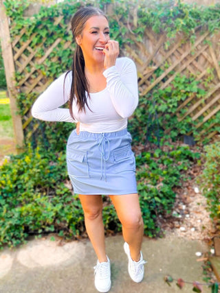 Close-up view of the cargo details and vegan leather texture of the Campbell Cargo Vegan Leather Mini Skirt