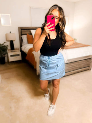 Close-up view of the cargo details and vegan leather texture of the Campbell Cargo Vegan Leather Mini Skirt