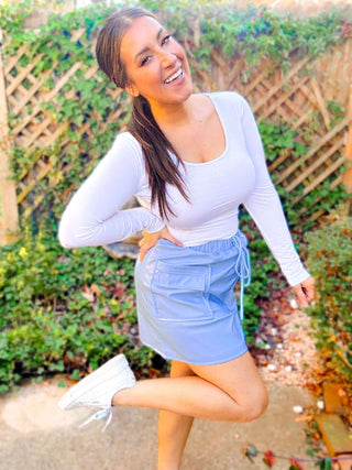 Close-up view of the cargo details and vegan leather texture of the Campbell Cargo Vegan Leather Mini Skirt