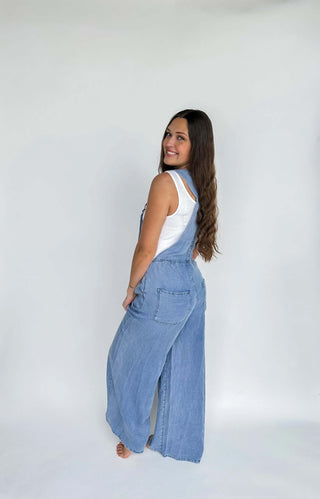 Back view of the denim fabric and boho design details of the Boho Jean Overalls.