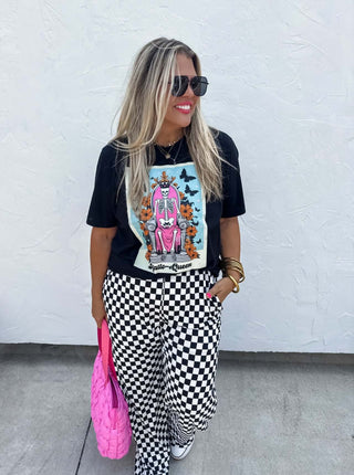 Woman wearing the Bold Block Checker Pants, styled casually with a top for a bold, trendy look.