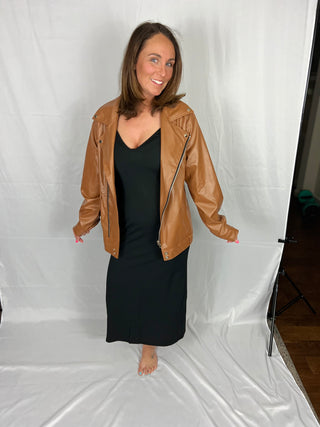 Woman wearing the Bridgette Bodycon Ribbed Dress, styled casually for a chic, feminine look.