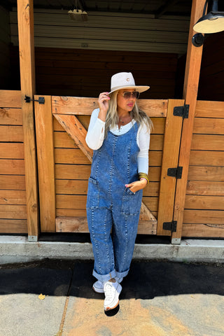 Woman wearing the Britte Romper Overalls, styled casually for a playful, chic look.