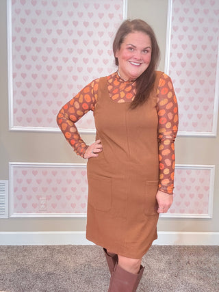 Sheer mesh long sleeve top with pumpkin print, mock neckline, and lettuce hems — lightweight, stretchy, and perfect for layering for fall style.