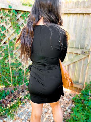 Woman wearing the Carrie Crossover Waist Faux Wrap Dress, styled for a chic and elegant look perfect for any occasion.