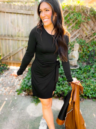 Woman wearing the Carrie Crossover Waist Faux Wrap Dress, styled for a chic and elegant look perfect for any occasion.