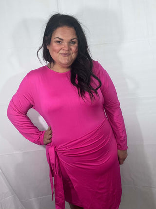 Woman wearing the Carrie Crossover Waist Faux Wrap Dress, styled for a chic and elegant look perfect for any occasion.