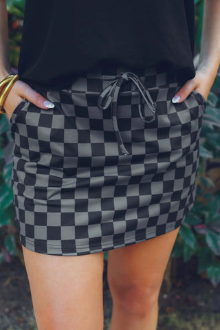 Close-up view of the checkered pattern and fabric of the Check Back Checkered Skort, highlighting its comfortable and functional design.