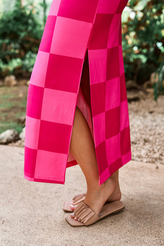 Close-up view of the checkered pattern and fabric texture on the Pink Checked Out Checkered Dress.