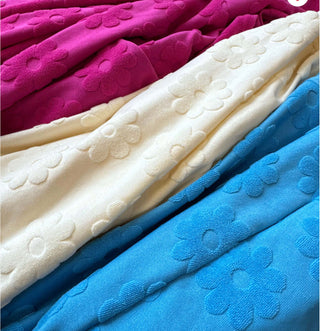 Close-up view of the soft fabric and pocket details on the Cambrie Pocket Romper, highlighting its comfortable design.