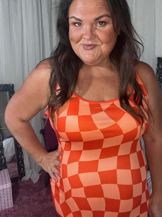 Woman wearing the Bishop Checkered Bodycon Dress, styled for a chic, bold look perfect for a night out or event.