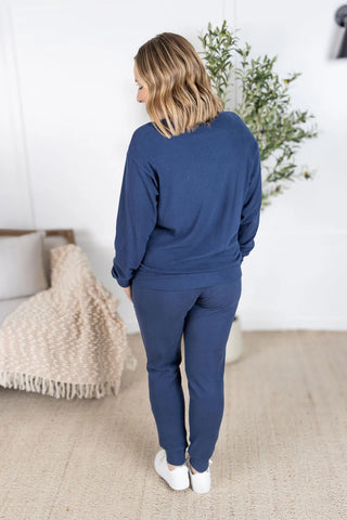 Back view of the Corrine Pullover showcasing long sleeves, ribbed fabric detail, and soft drape for a cozy yet flattering fit.