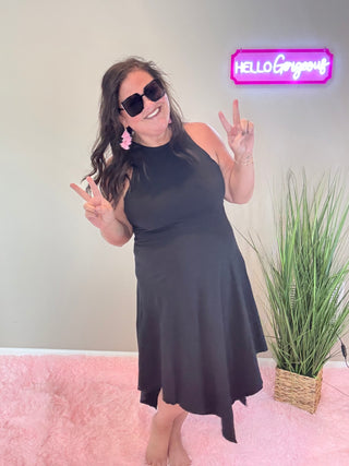 Front view of tank dress featuring an asymmetric hemline and soft slub cotton fabric in black.