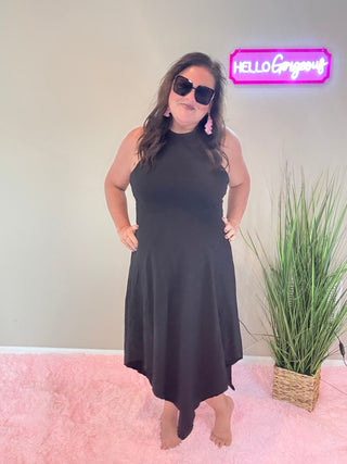 Model wearing Asymmetric Hem Dani Tank Dress with raw edge details and breezy, relaxed fit in black.