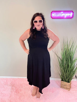 Model wearing Asymmetric Hem Dani Tank Dress with raw edge details and breezy, relaxed fit in black.