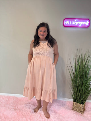 Model wearing dusty rose crochet dress featuring a vintage-inspired crochet bodice and flowing maxi skirt.
