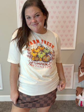 Natural-colored “Farm Fresh Pumpkins” tee with hand-placed crystals, paired with a brown skort for a cozy fall look; soft cotton fabric and sparkling detail make it perfect for pumpkin patch days and crisp autumn outings.