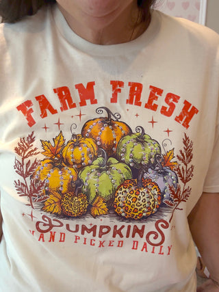 Natural t-shirt with 'Farm Fresh Pumpkins' graphic design with crytals on a person wearing it.