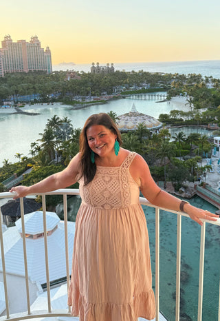 Model wearing dusty rose crochet dress featuring a vintage-inspired crochet bodice and flowing maxi skirt.