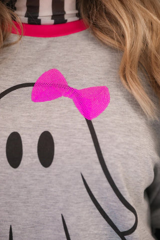 Gray sweatshirt with a pink bow and black ghost design