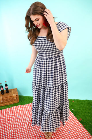 Model turning slightly to show the back of the Parks and Picnics Dress, with a flowy tiered skirt.
