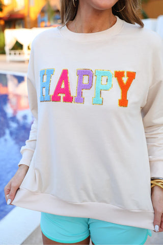 Front view of cozy pullover with soft fabric and cheerful smiley face patch design.