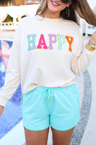 Happy Patch Pullover styled with everyday shorts and sneakers for a relaxed, casual look.