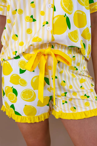 Person wearing a lemon-patterned outfit with a white background