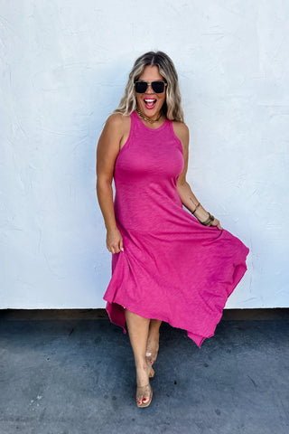 Model wearing Asymmetric Hem Dani Tank Dress with raw edge details and breezy, relaxed fit in pink.