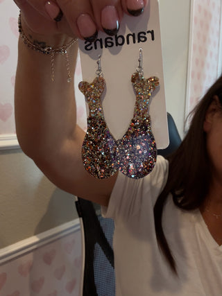 Acrylic turkey leg–shaped earrings covered in chunky autumn-toned glitter, displayed on a “randans” branded card.