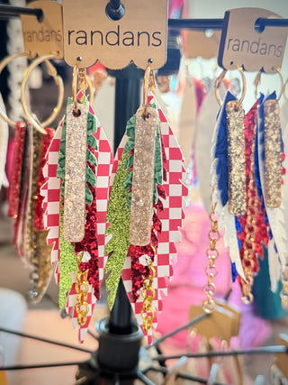 Colorful checkered earrings on a 'randans' branded display stand.