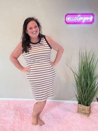 Front view of chic ribbed dress with body-hugging silhouette and subtle, stylish stripes.