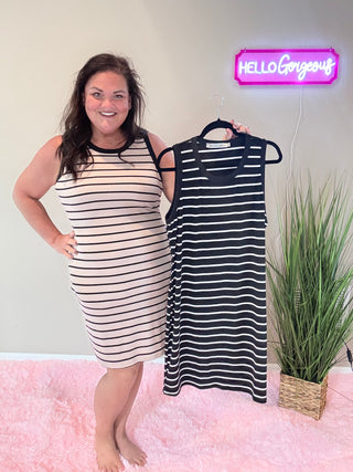 Model wearing Mariah Ribbed Dress featuring form-fitting ribbed fabric and mocha stripe detailing.