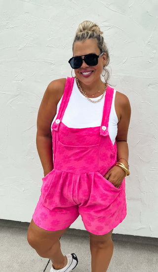 Woman wearing the Cambrie Pocket Romper, styled casually with sneakers for a relaxed, chic look.