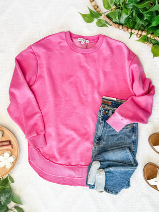 Pink Washed Sweatshirt displayed flat, showcasing its soft fabric and relaxed fit.
