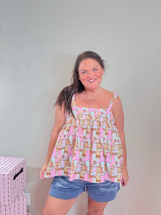 Rodeo Ruffle Sleeveless Top with Boot Pattern – Flowy sleeveless top featuring a playful boot pattern, soft cotton feel, and relaxed fit.
