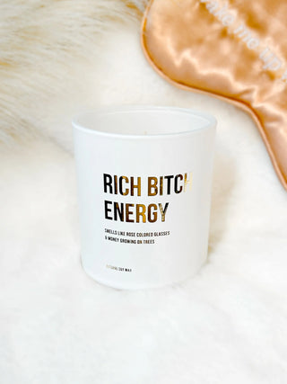 Rich B+ch Energy Candle displayed flat, showcasing its bold design and luxurious candle jar."