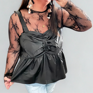 Woman wearing the Rodeo Ribbon Midnight Peplum Tank, styled casually for a chic and feminine look.